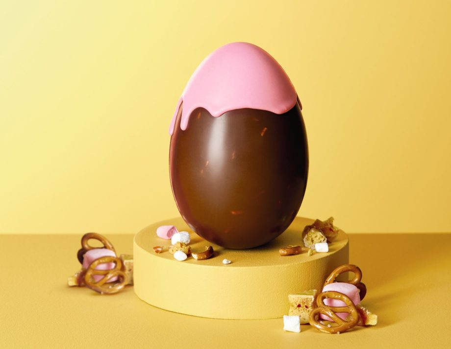 Milk chocolate egg with pink coloured chocolate drizzle over the top