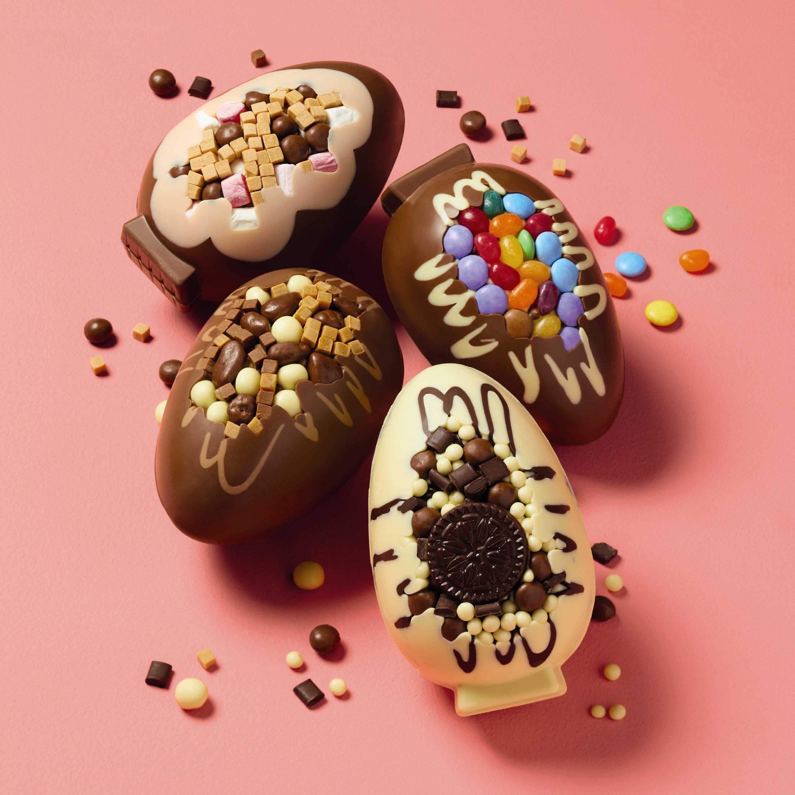 Alid's front loaded eggs, four on a pink background, showcasing the Rocky Road, Popping Candy, Cookies & Cream and Billionaire filling.