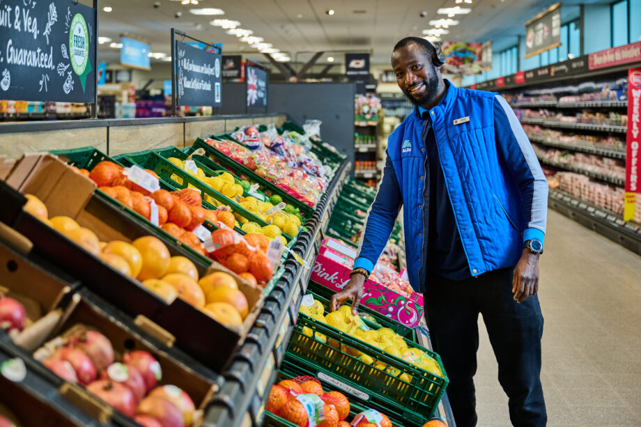 Aldi colleague in the fruit and veg aisle